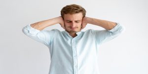 A man covering his ears depicting ignorance